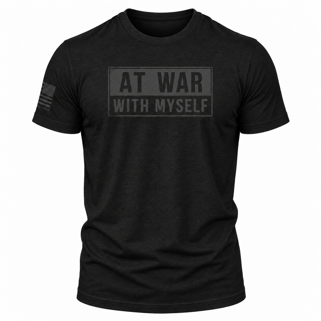 A black short-sleeve crewneck t-shirt with a tonal dark gray graphic on the chest reading 'AT WAR WITH MYSELF' inside a rectangular border, and a small tonal American flag graphic on the right sleeve, shown on a plain white background.