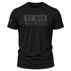 A black short-sleeve crewneck t-shirt with a tonal dark gray graphic on the chest reading 'AT WAR WITH MYSELF' inside a rectangular border, and a small tonal American flag graphic on the right sleeve, shown on a plain white background.