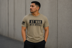 A man wearing a heathered tan t-shirt with a black graphic that reads 'AT WAR WITH MYSELF' on the chest, standing against a concrete wall.