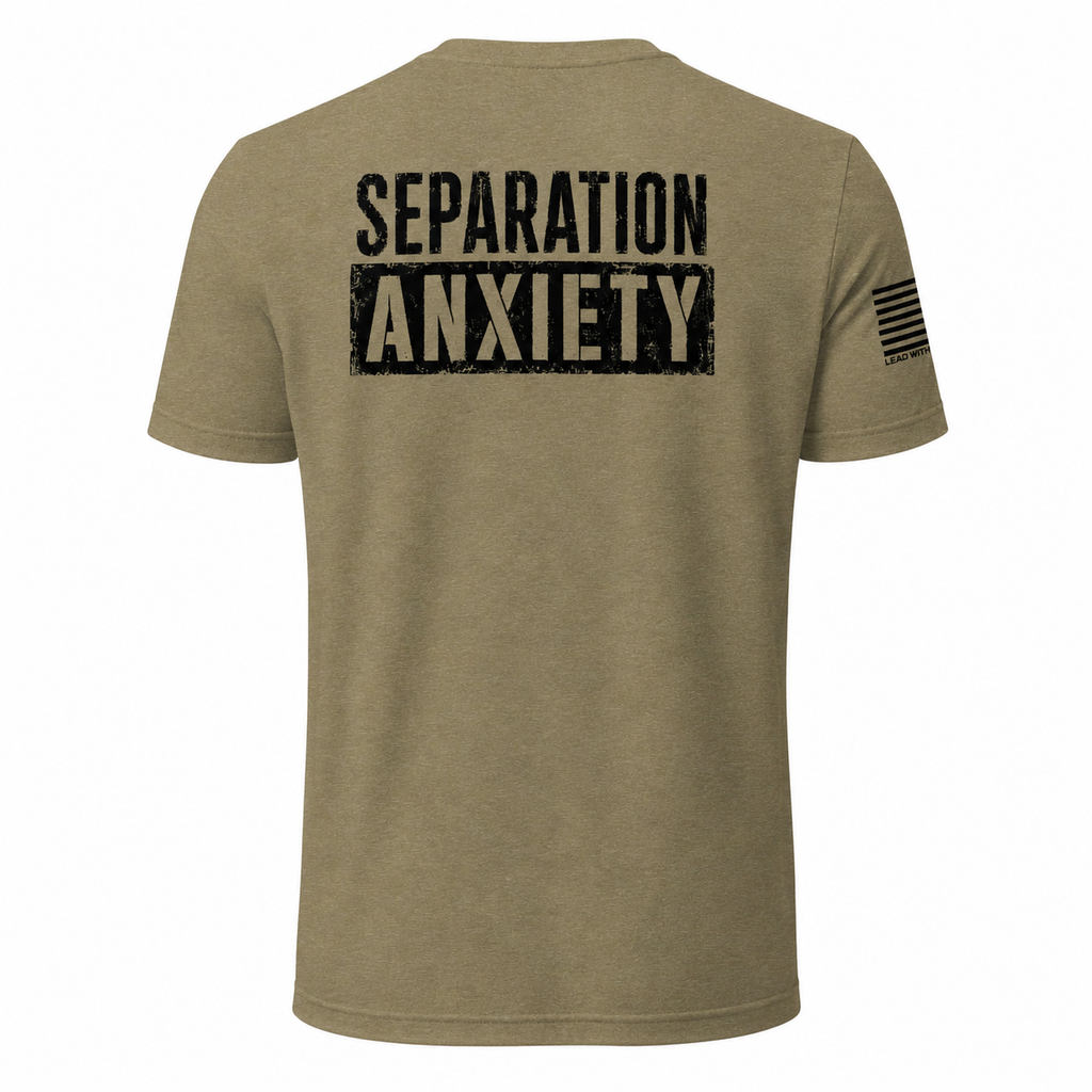 A heathered olive green short-sleeve t-shirt shown from the back, featuring the words 'SEPARATION ANXIETY' printed in a distressed black font across the upper back, and a black American flag graphic on the left sleeve.