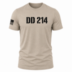 A short-sleeve crewneck t-shirt in a light tan/beige color, featuring the distressed black text 'DD 214' across the chest and a black American flag graphic on the right sleeve, shown on a plain white background.