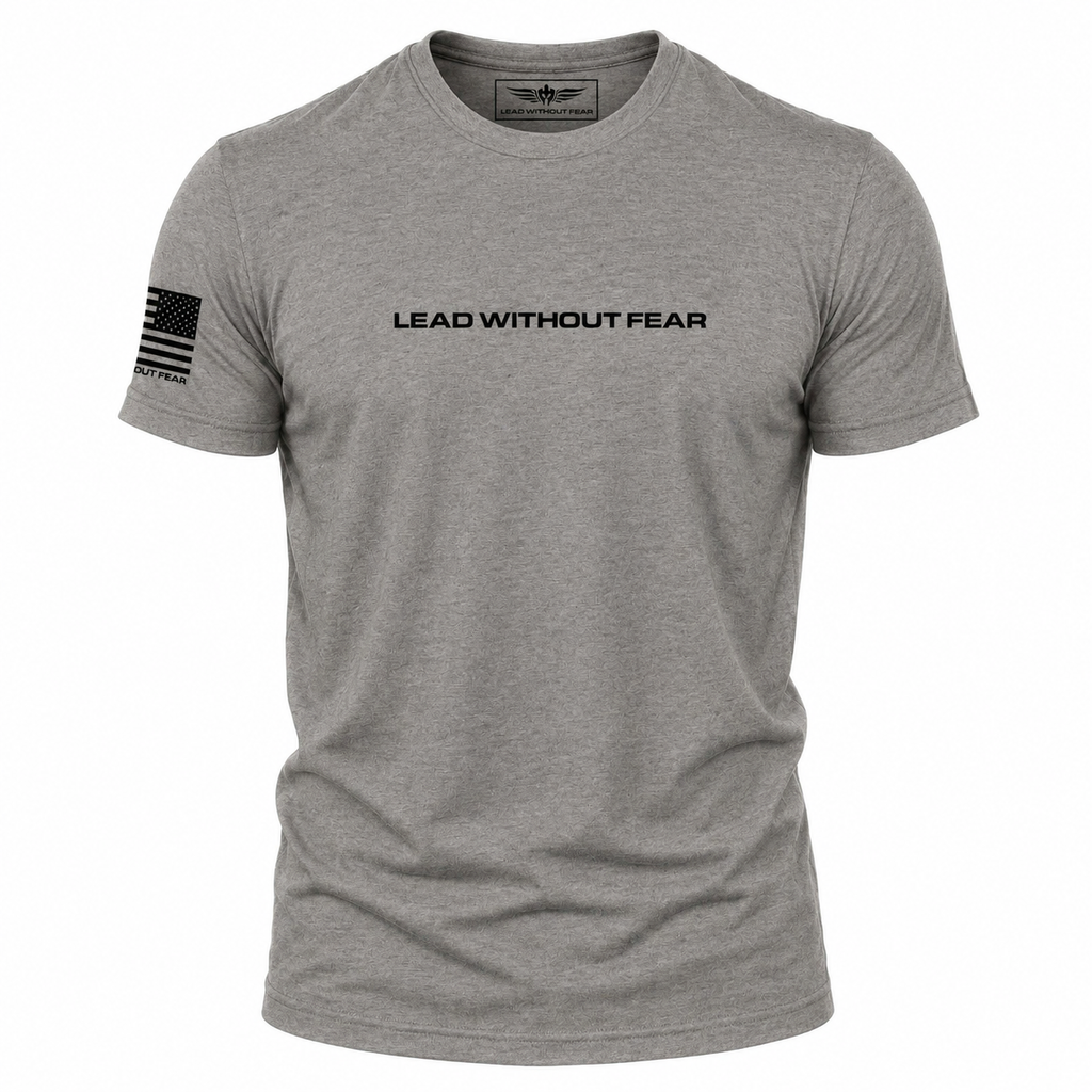 A heather gray short-sleeve crewneck t-shirt with 'LEAD WITHOUT FEAR' printed in black across the chest and a black American flag graphic on the right sleeve, shown on a plain white background.