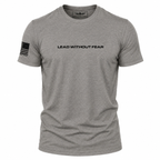 A heather gray short-sleeve crewneck t-shirt with 'LEAD WITHOUT FEAR' printed in black across the chest and a black American flag graphic on the right sleeve, shown on a plain white background.