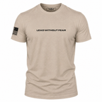 A light tan crewneck t-shirt with 'LEAD WITHOUT FEAR' printed in black across the chest and a black American flag graphic on the right sleeve, shown on a plain white background.