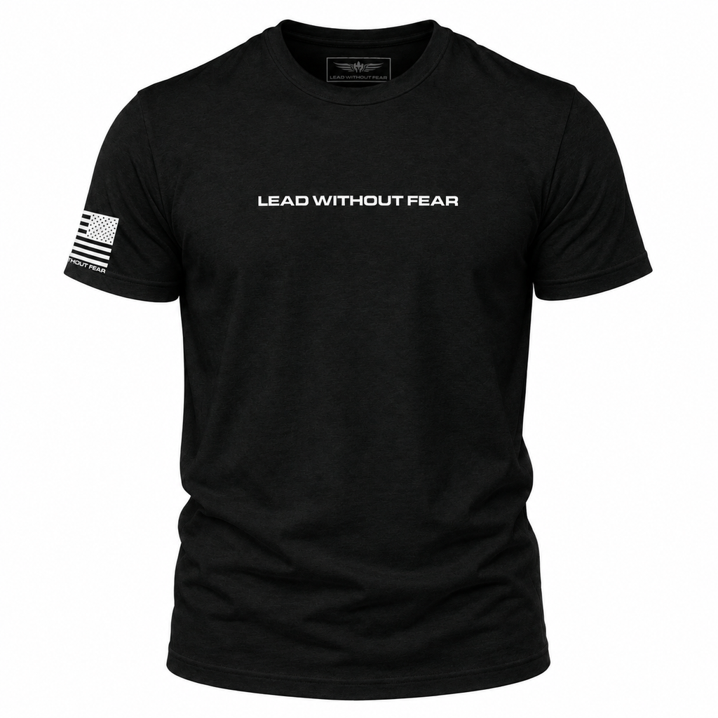 A black short-sleeve crewneck t-shirt with 'LEAD WITHOUT FEAR' printed in white across the chest and a white American flag graphic on the right sleeve, shown on a plain white background.