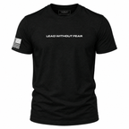 A black short-sleeve crewneck t-shirt with 'LEAD WITHOUT FEAR' printed in white across the chest and a white American flag graphic on the right sleeve, shown on a plain white background.