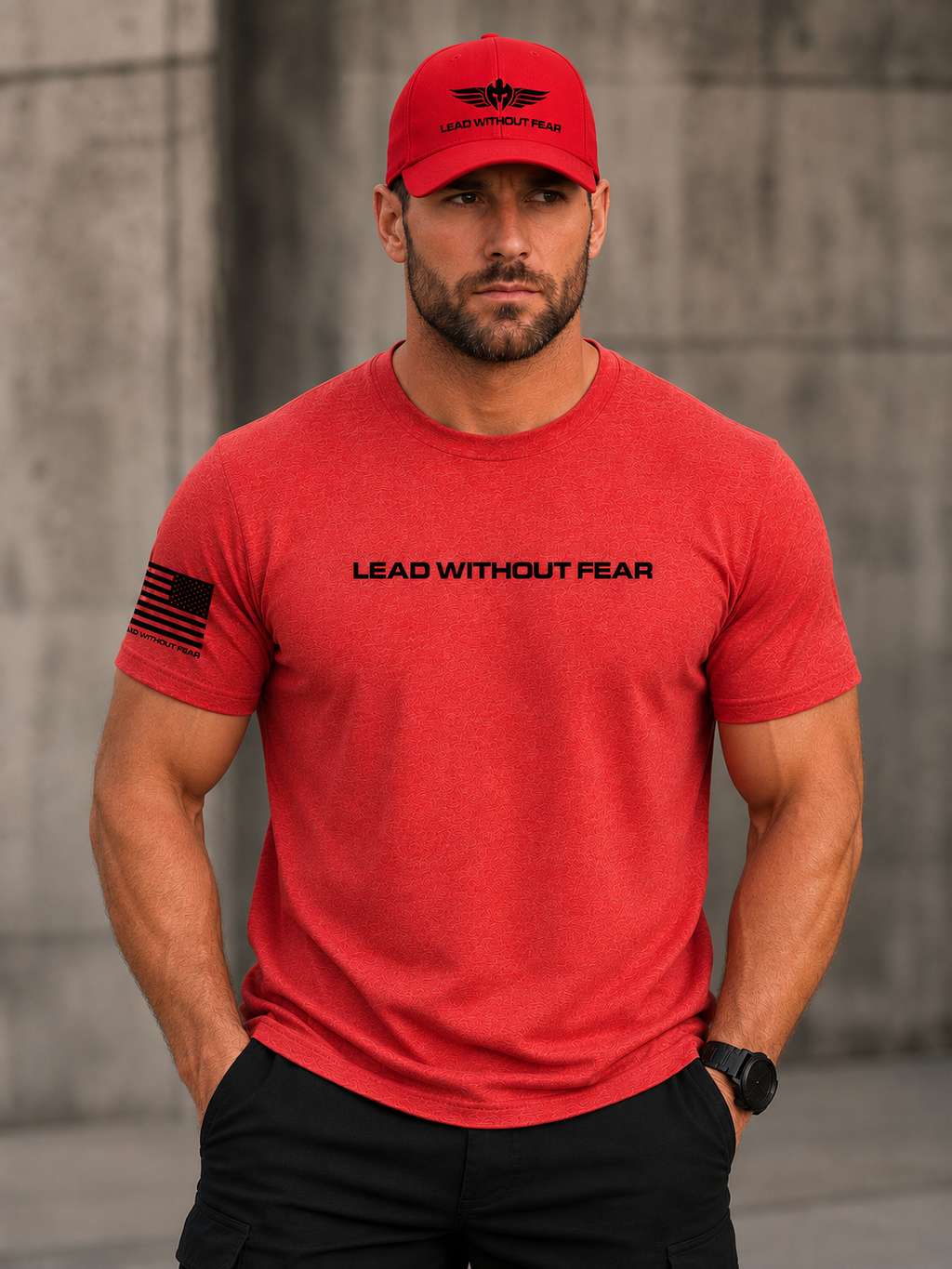 A man wearing a red crewneck t-shirt with 'LEAD WITHOUT FEAR' printed across the chest and a black American flag graphic on the sleeve, paired with a matching red baseball cap.