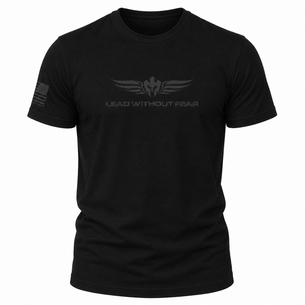 A black short-sleeve crewneck t-shirt featuring a dark gray winged emblem and the text 'LEAD WITHOUT FEAR' printed on the chest, with a small American flag graphic on the right sleeve, shown against a plain white background.
