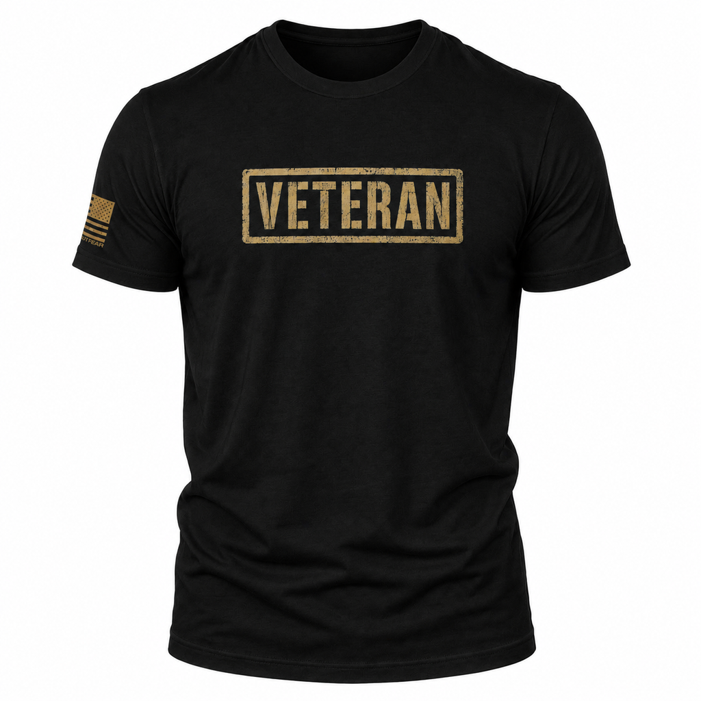A black short-sleeve crewneck t-shirt featuring a distressed tan rectangular 'VETERAN' box logo on the chest and a small tan American flag graphic on the right sleeve, shown against a plain white background.