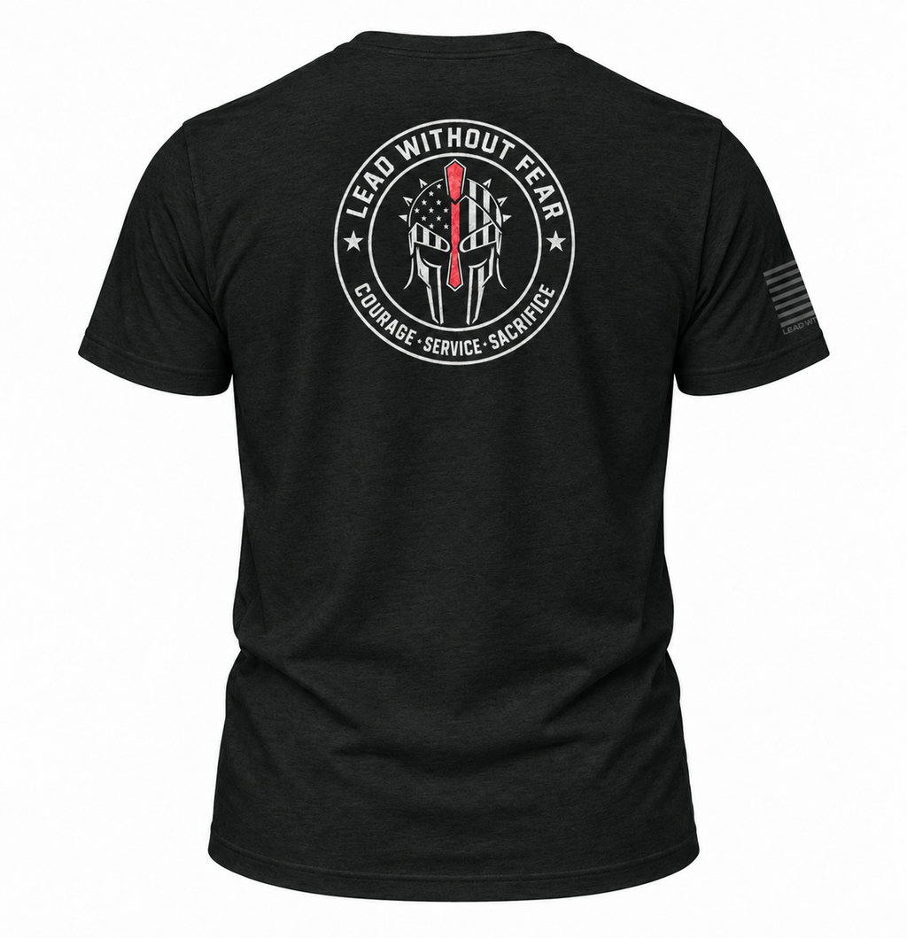 A black short-sleeve t-shirt shown from the back, featuring a large circular white graphic with a Spartan helmet, an American flag, and the text 'LEAD WITHOUT FEAR' and 'COURAGE - SERVICE - SACRifice'. A small black flag graphic is printed on the right sleeve.