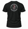 A black short-sleeve t-shirt shown from the back, featuring a large circular white graphic with a Spartan helmet, an American flag, and the text 'LEAD WITHOUT FEAR' and 'COURAGE - SERVICE - SACRifice'. A small black flag graphic is printed on the right sleeve.