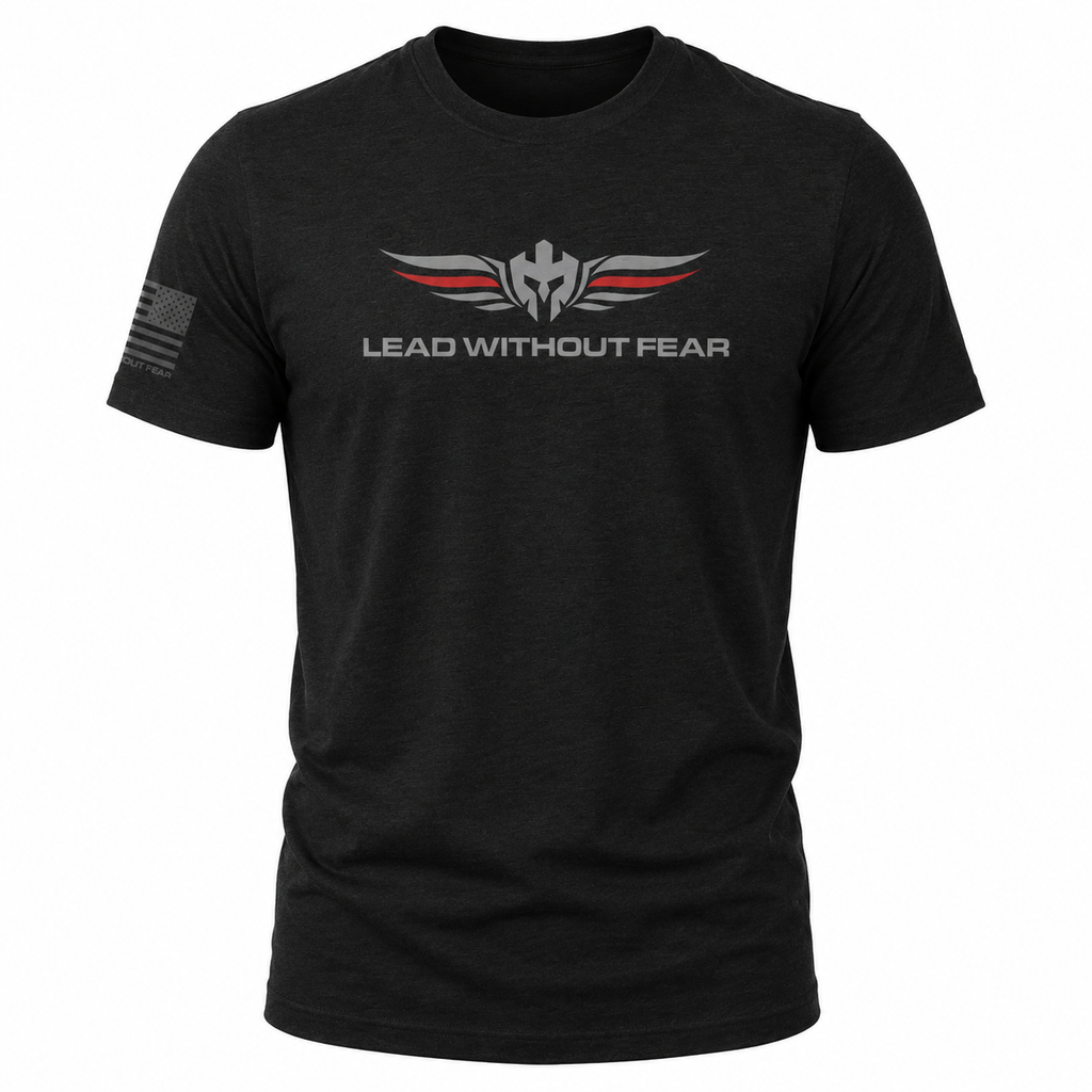 A black short-sleeve t-shirt with a 'LEAD WITHOUT FEAR' graphic on the chest featuring a winged helmet emblem in gray and red, and a distressed gray American flag on the right sleeve, shown on a plain white background.