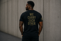 Veteran We Carry Each Other Back military tee shirt with male model.