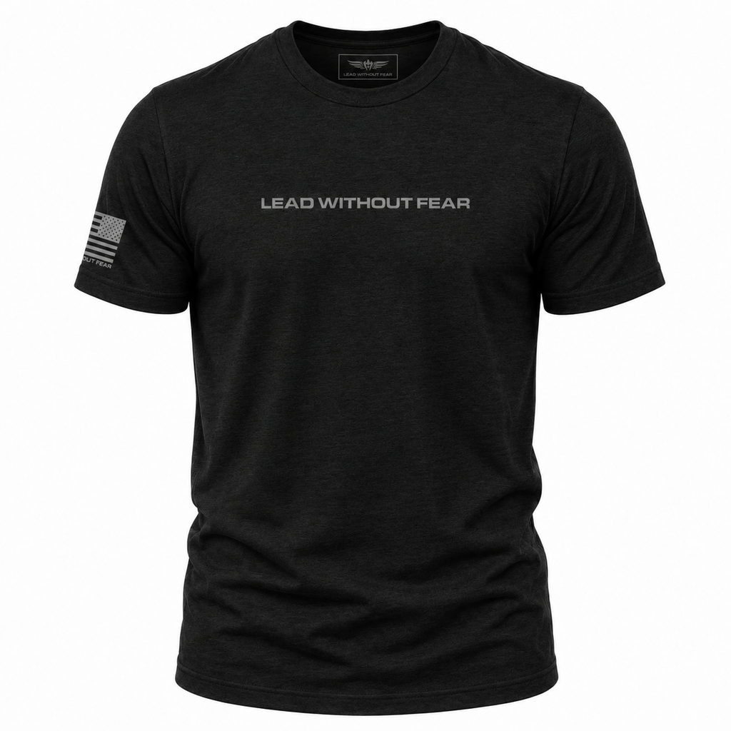 A black short-sleeve crewneck t-shirt with 'LEAD WITHOUT FEAR' printed in white across the chest and a small American flag graphic on the right sleeve, shown on a plain white background.