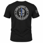 Black short-sleeve t-shirt shown from the back, featuring a large circular white graphic with a blue line-art element and the text 'LEAD WITHOUT FEAR' and 'INSPIRE COURAGE LIVE YOUR MISSION.' A smaller black flag-style print appears on the left sleeve.